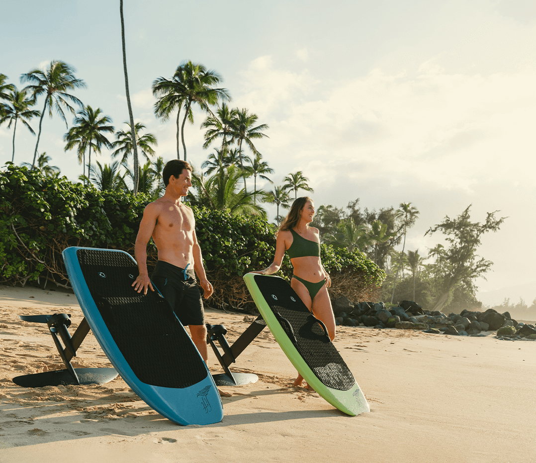 Two people standing on the beach with surfboards, ready for a lesson in a tropical setting. Perfect for couples!